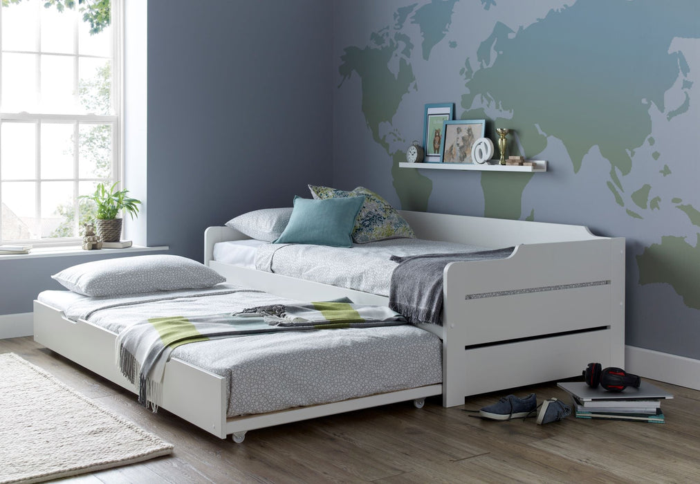 White wooden guest bed with trundle.